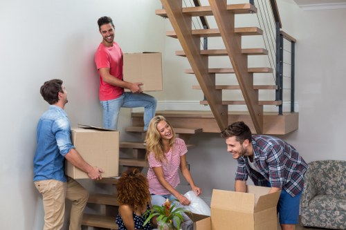 Professional movers navigating apartment access in Canning Town