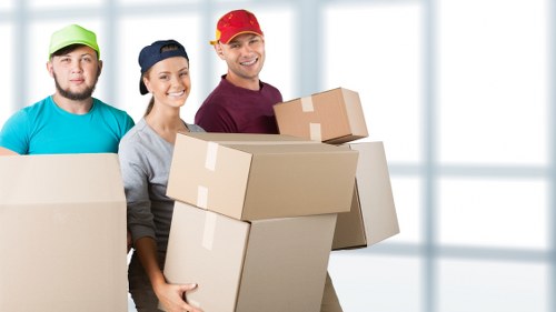 Moving crew assessing packing and lifting risks before loading