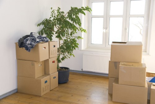 Packed moving boxes and furniture ready for collection in East London