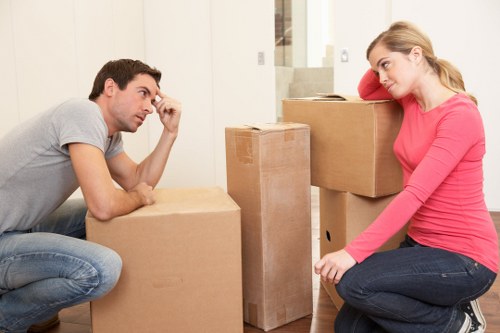 Professional movers carrying furniture through a residential building