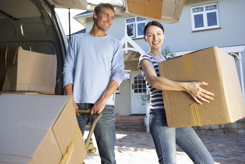 Local moving team handling boxes near Canning Town apartments